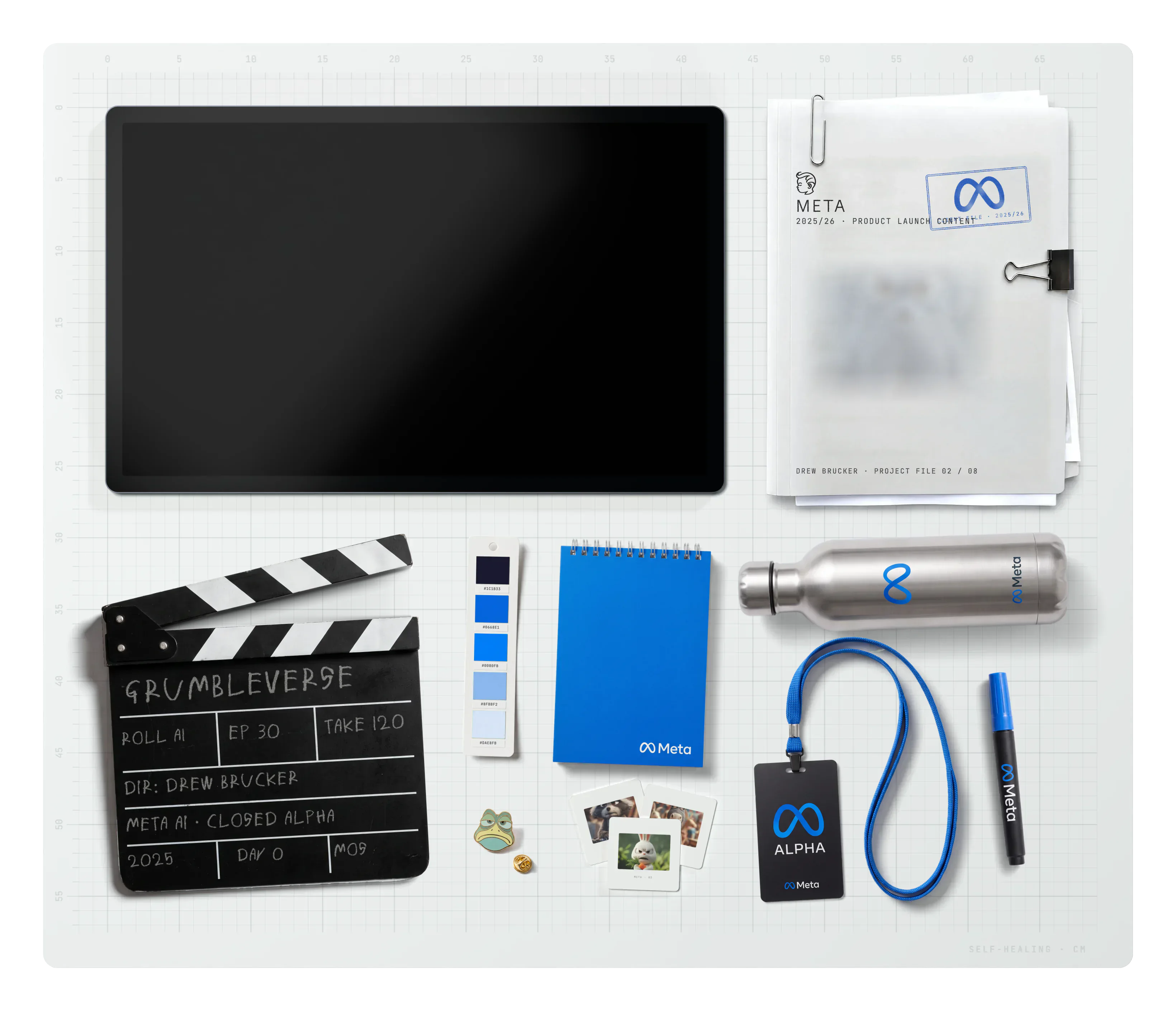 Meta on the desk: the project file, a Grumbleverse clapperboard, the brand swatch, a notebook, a water bottle, slides, an ALPHA lanyard badge, a Meta marker and a Grumbleverse frog pin